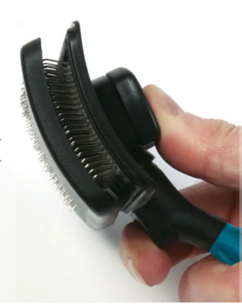 Self-cleaning slicker brush with stainless steel grooming pins